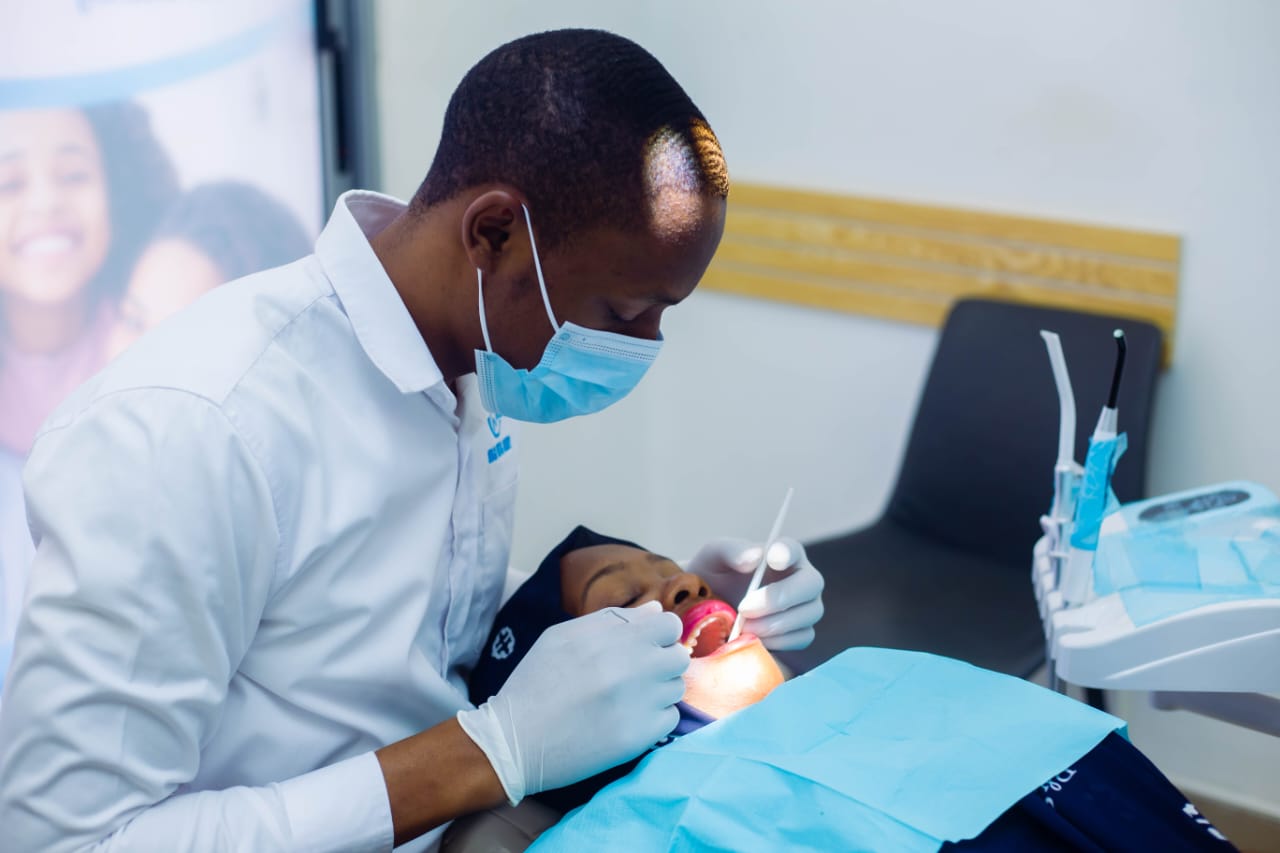 A dentist at Rubaga Dental Surgery treating a patient