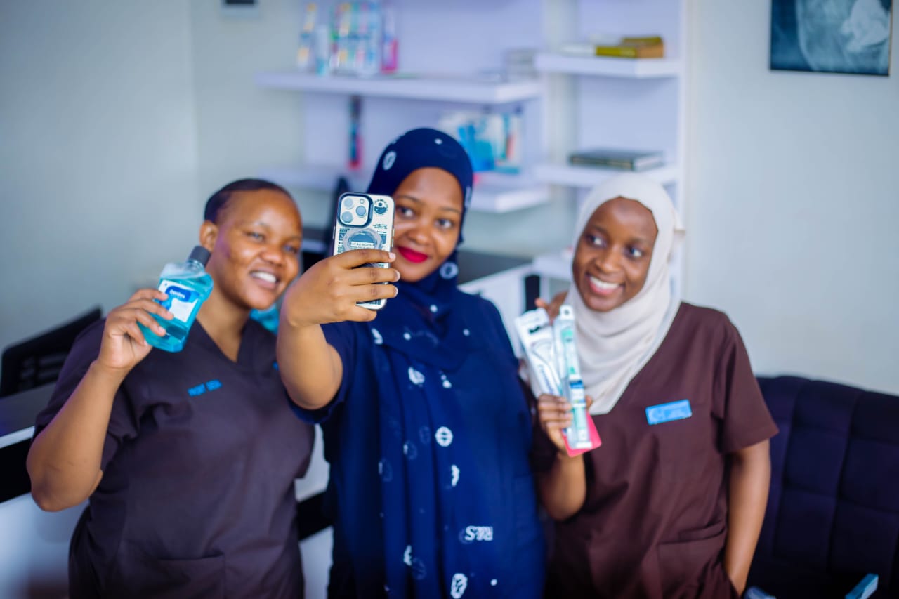 The Rubaga Dental Surgery team with oral care products
